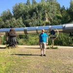 Sam in front of Alaskan Pipeline near Fairbanks