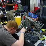 Sam checking Team 1320C robot before start of matches