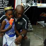 Coach William Hicks with granddaughter keeping watch over the Tucker HS pits at VEX World Championships in Lexington, KY