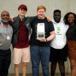 Mr. Hicks with Team 1320C members James, Sam, Mamadou, and Deborah after receiving the Division Service Award at VEX World Championships in Louisville, KY, April 27, 2019