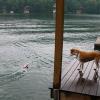 Molly watches RC powerboat from dock