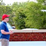Sam flies quadcopter at rugby field at Furman