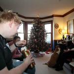 Sam, Julia and Grandmother opening presents with Molly watching every move