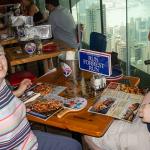 Sam and Julia at Bubba Gump Restaurant at top of Victoria Peak, note view of Hong Kong from our table