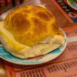 Kam Wah pineapple bun contains no pineapple, named for appearance of top of bun and always served with thick patty of butter inside
