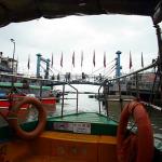 Wrought iron pedestrian footbridge in Tai O fishing village as seen from tour motorboat