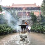 Entrance to Po Lin Monastery with incense burning in foreground