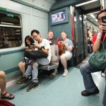 Only tourists ride the MTR without looking at their cell phones