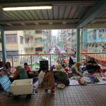 Thousands of immigrant workers, almost entirely Islamic women from Southeast Asian countries, meet on covered walkways of Mong Kok MTR station to share meals, games, and conversation on their day off