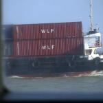 TurboJET Ferry overtakes small container vessel
