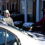 Julia and Sam clear snow and ice from Sam's car