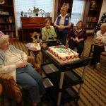 Grandmother with fellow residents of Atria Park of Tucker waiting for birthday cake