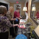 Julia and Sandy along with Atria Park of Tucker staff person prepare to serve the birthday cake