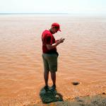 Sam checks rate of tidal rise at Hopewell Rocks