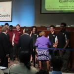 Members of the DeKalb County Board of Education shake hands with Tucker HS robotics students