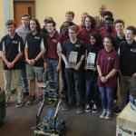 Tucker HS principal Dr. Eric Parker joins Tucker HS robotics students for photo