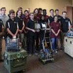 Coach William Hicks joins Tucker HS robotics students for photo