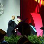 Sam congratulated by Dr. Eric Parker, principal of Tucker HS