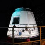 Recovered SpaceX Dragon space vehicle with burn marks from re-entry on display at Kennedy Space Center Visitor Complex