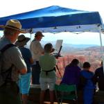 Water color artist in residence demonstrates techniques for early morning walkers on the Sunrise Point to Sunset Point rim trail at Bryce Canyon NP