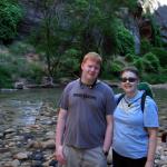 Sam and Julia stand at edge of North Fork of the Virgin River at the beginning of the narrows in Zion NP